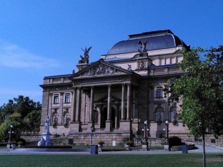 Wiesbaden - Blick auf die Marktkirche Blick auf eine Kirche mit mehreren Türmen, umgeben von Bäumen und grünem Gelände.